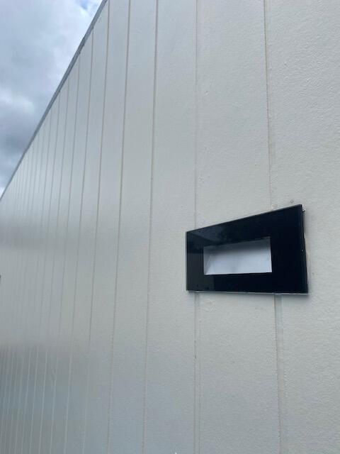 Flush mounted rectangular glass steplight on a wall